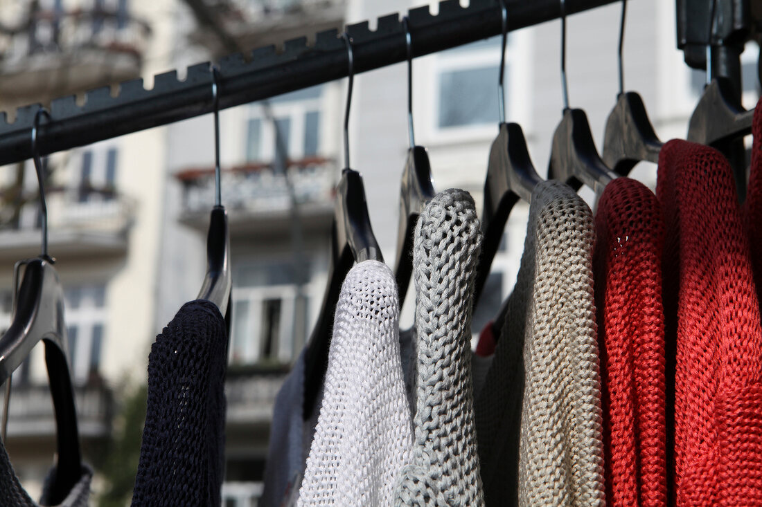 Colourful knit sweater on clothes rack in market