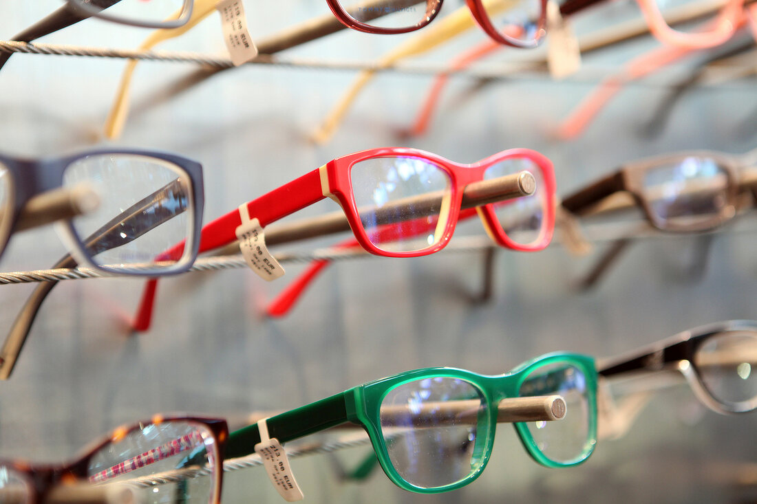 Close-up of various spectacles on display rack in store