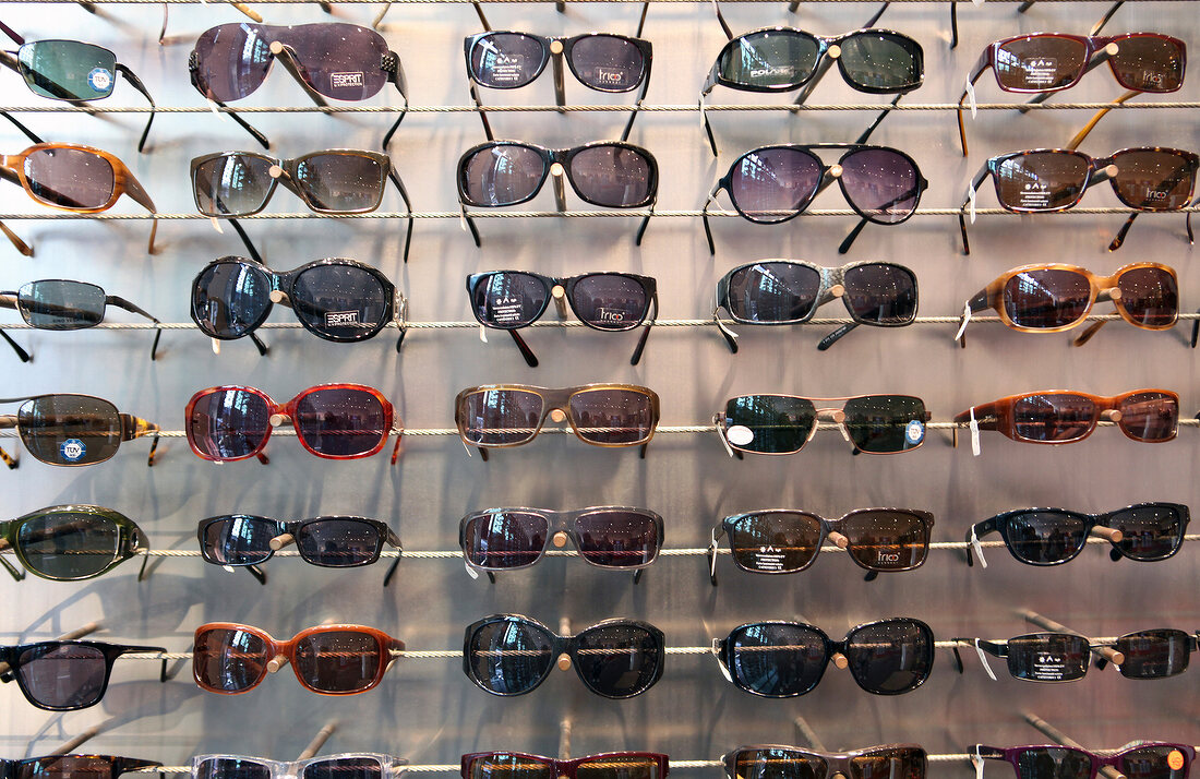 Various sunglasses on shelf at optician