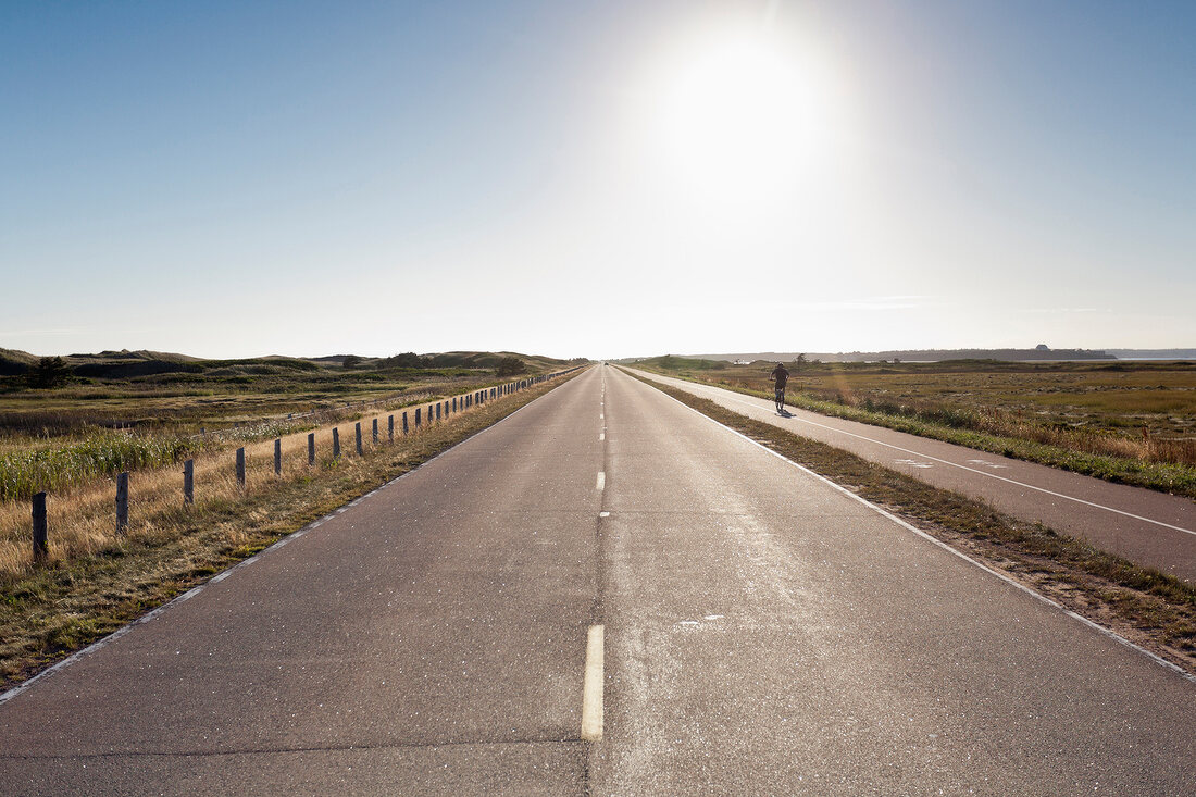 View of empty highway at Prince Edward Iceland National Park, backlight, Canada