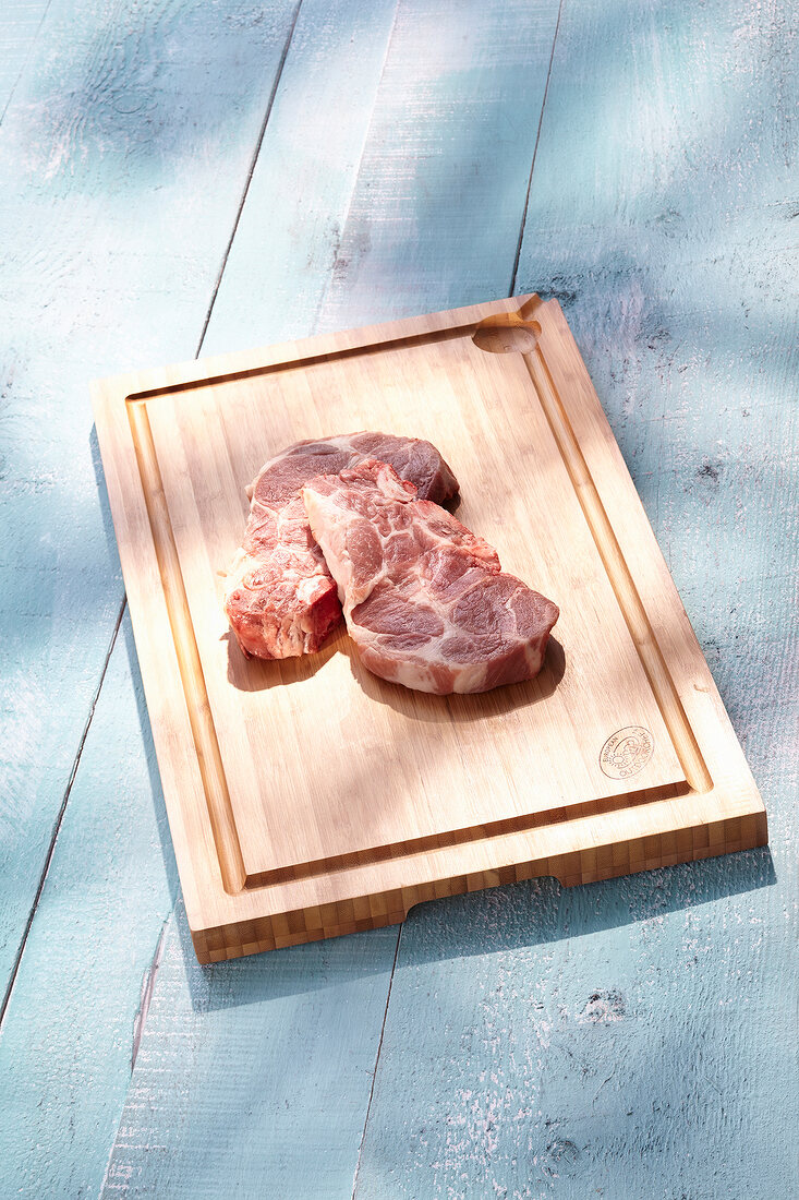 Pieces of steak on carved bamboo wood tray