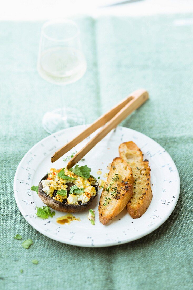 A Portobello mushroom filled with sheep's cheese and mint served with garlic bread