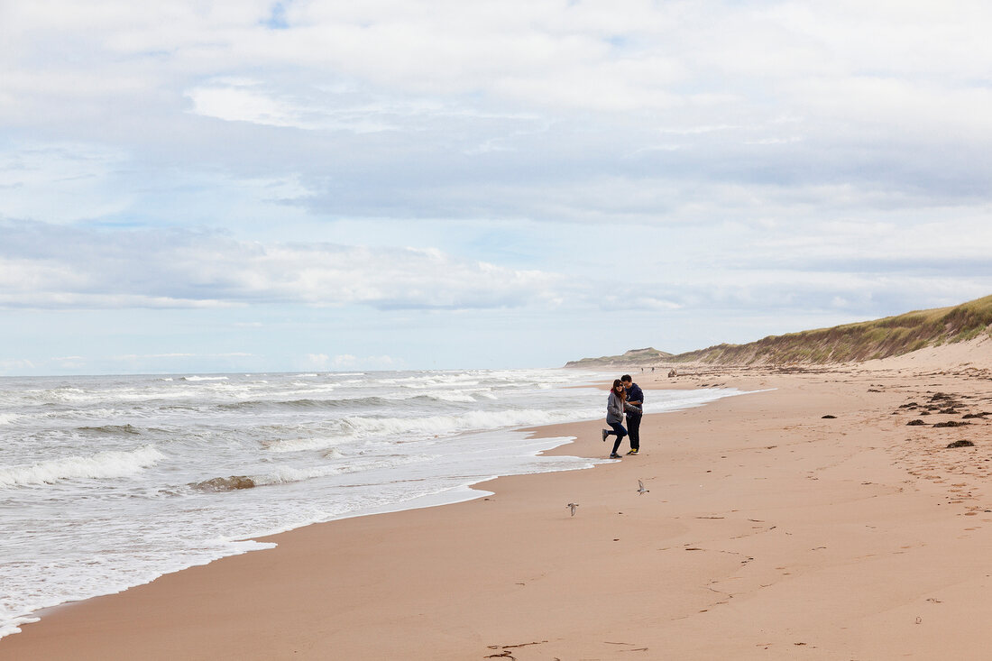 Couple standing on beach at Prince Edward Island, Greenwich, Canada
