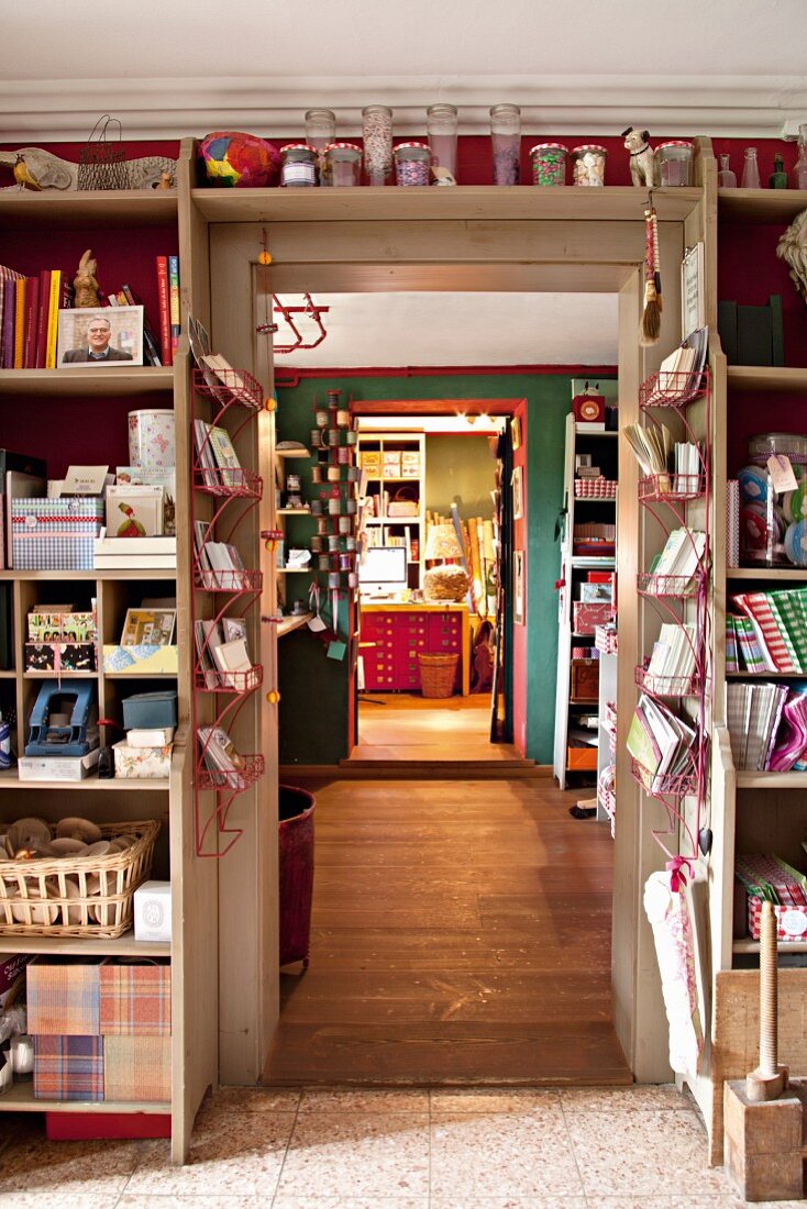 Shelves built around a doorframe with a view into the next room