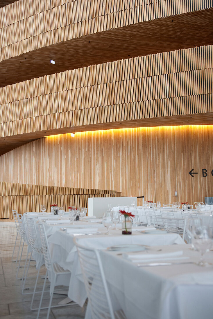 Laid tables near wooden staurs in Opera House at Oslo, Norway