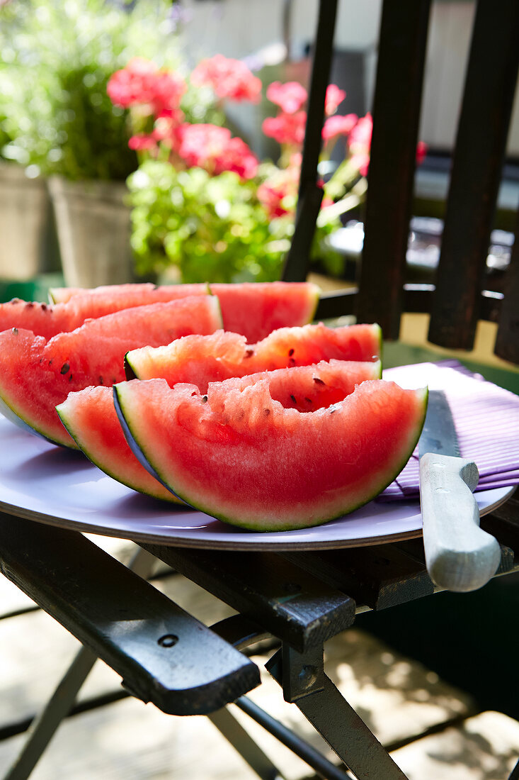 Slices of watermelon and knife on table