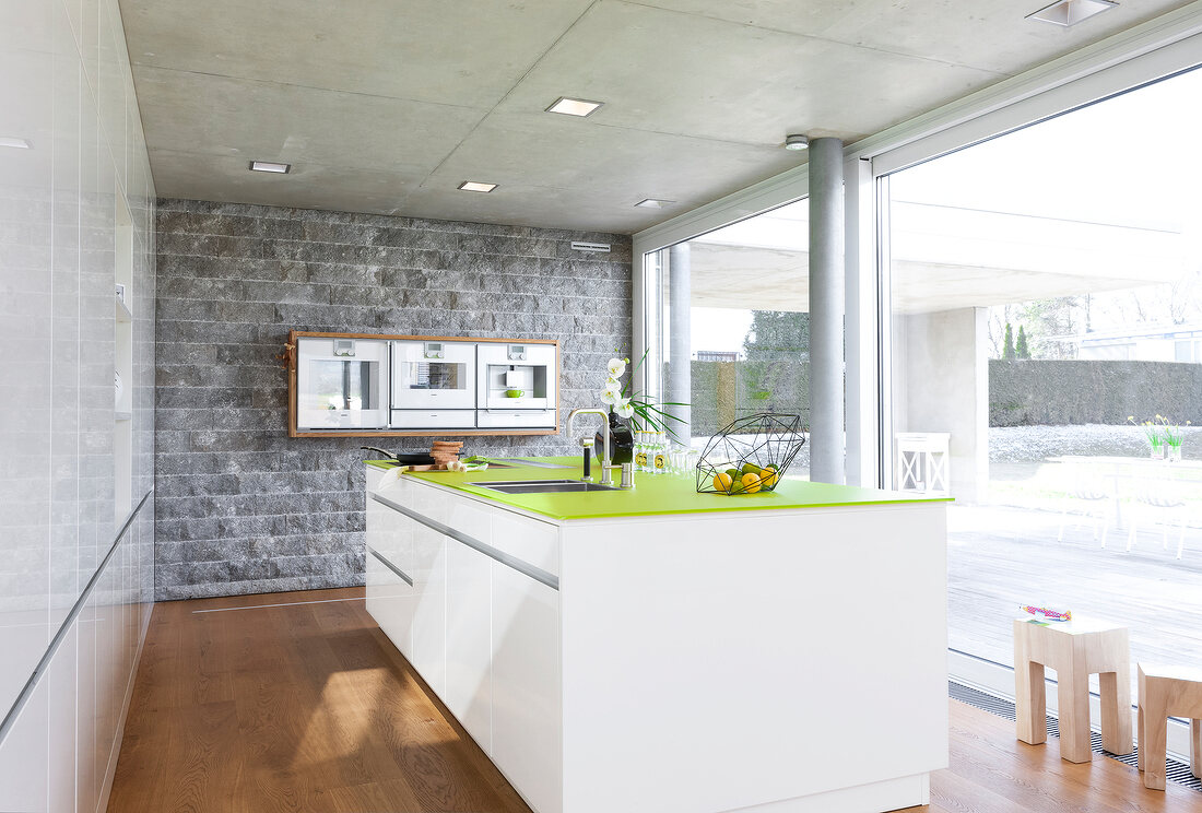 View of sink and green counter top in kitchen