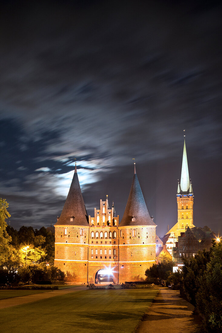 View of illumintaed Holstentor at night in Lubeck, Schleswig Holstein, Germany