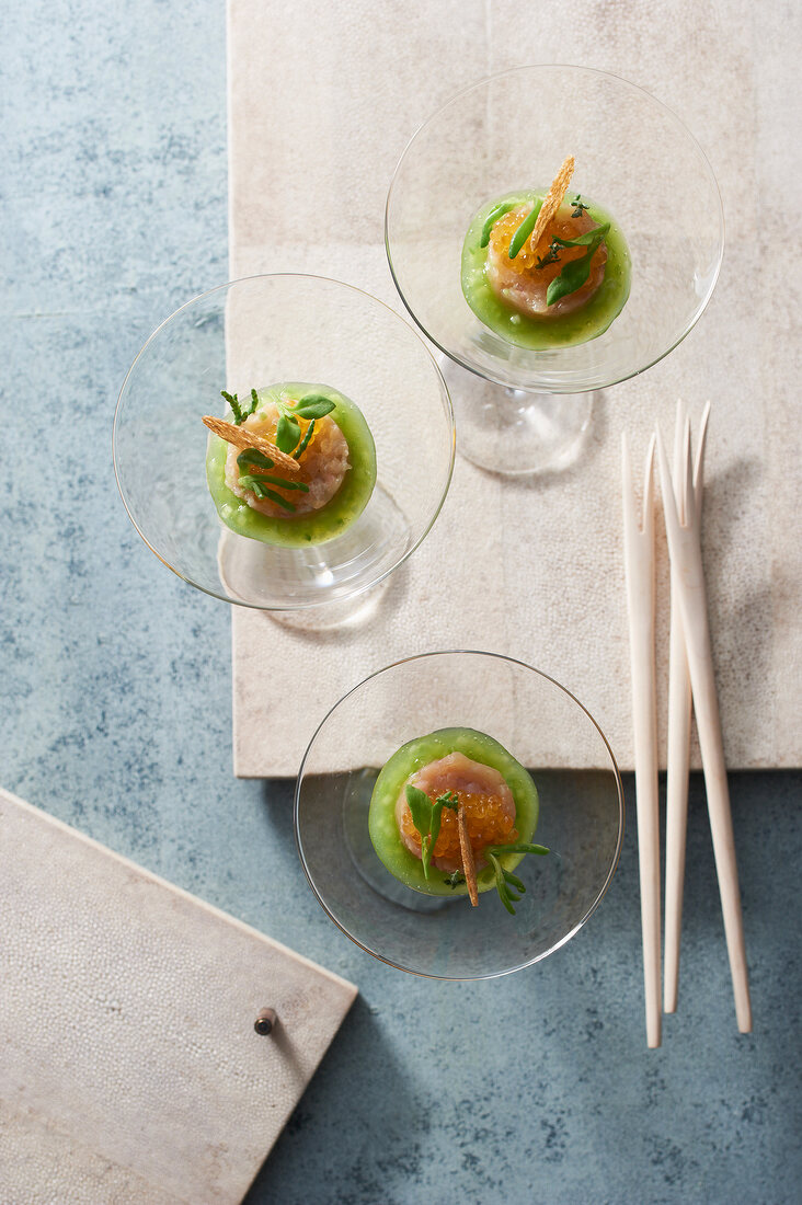 Char tartar with cucumber and char caviar in glasses, overhead view