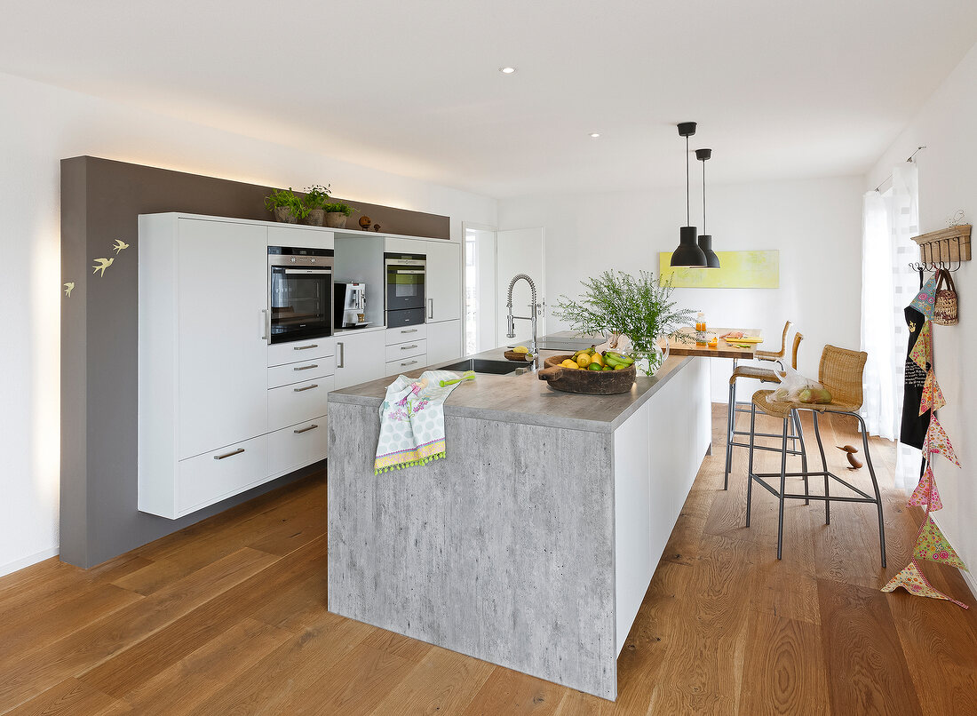 Dining area on kitchenette with stools in kitchen