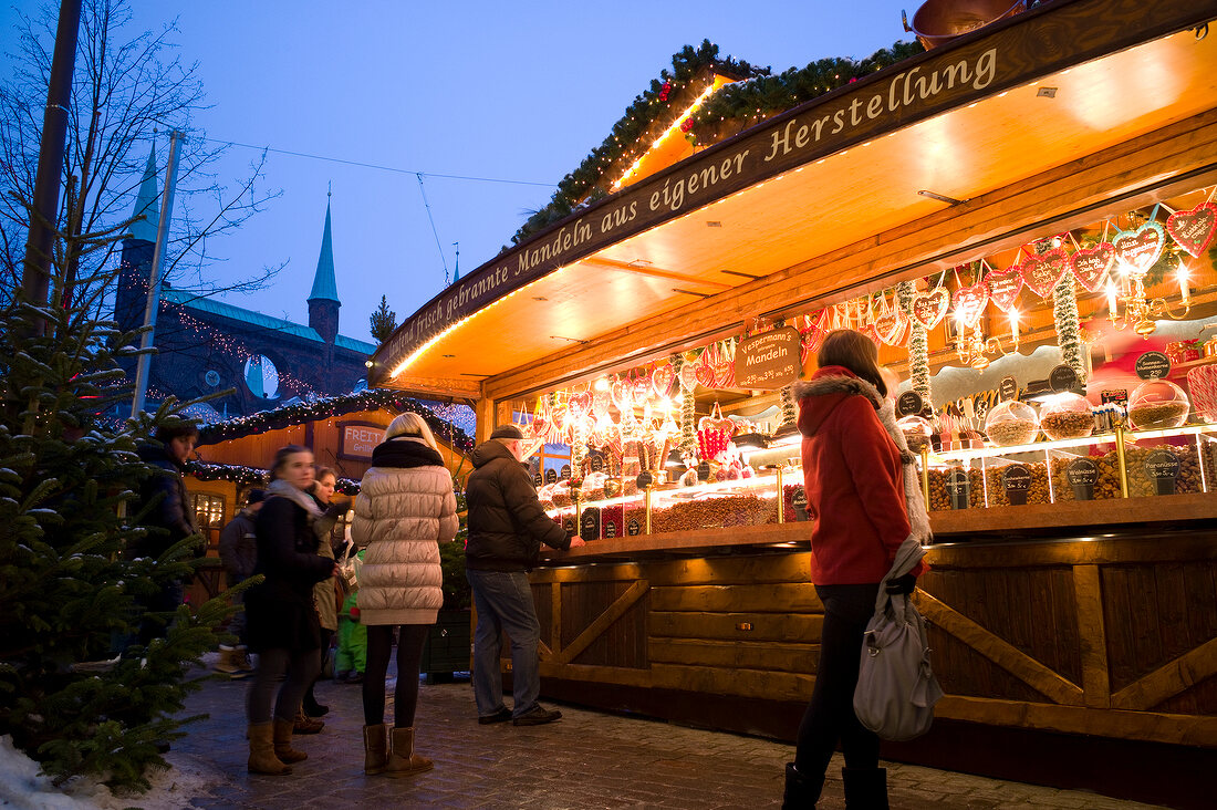People at Christmas market stall at Lubeck, Schleswig Holstein, Germany