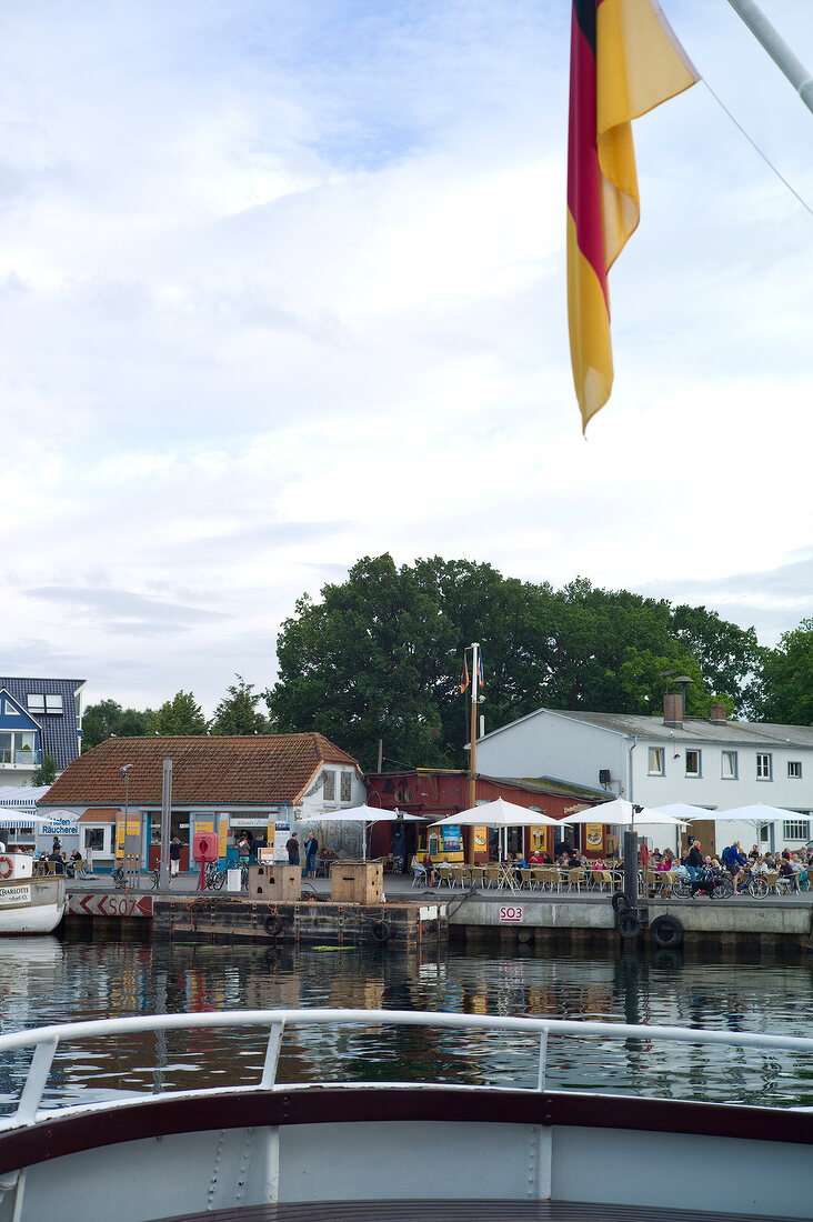 View of restaurant through boat, Niendorf harbour, Lubeck, Schleswig Holstein, Germany