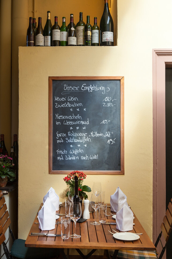 Laid table and black eagle wine in restaurant in the Scheunel, Freiburg, Germany