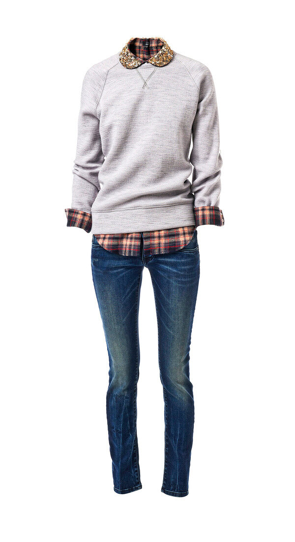 gray sweater over checked shirt and jeans on white background