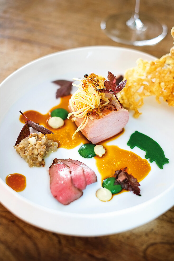 Close-up of suckling pig and buckwheat on plate