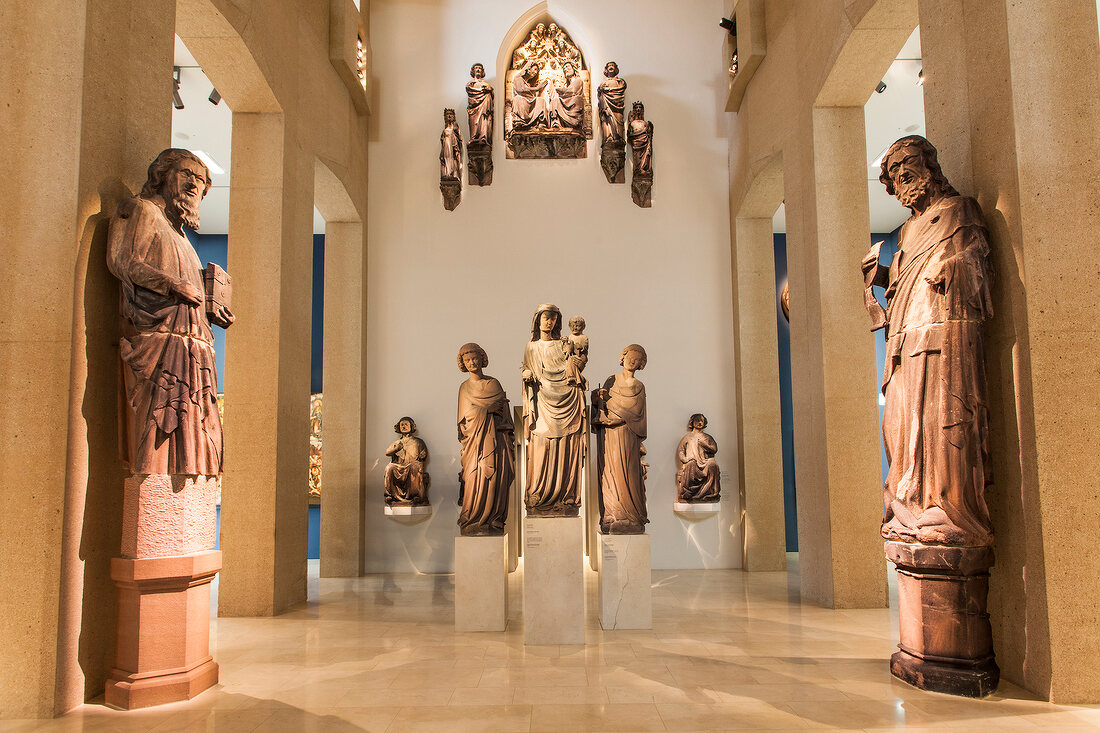 Children looking at sculptures of prophets in Munster at sculpture hall, Freiburg, Germany