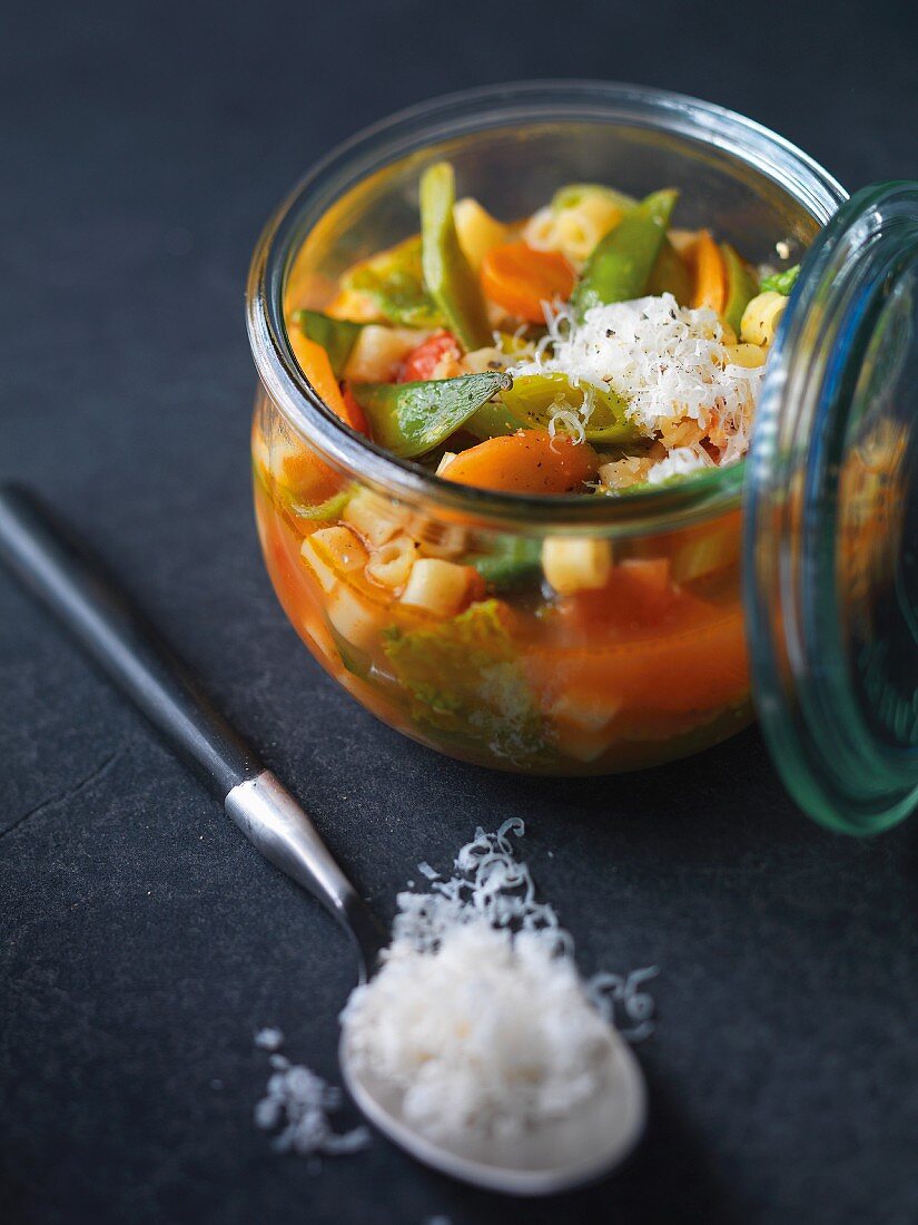 Minestrone soup with Parmesan cheese in a preserving jar