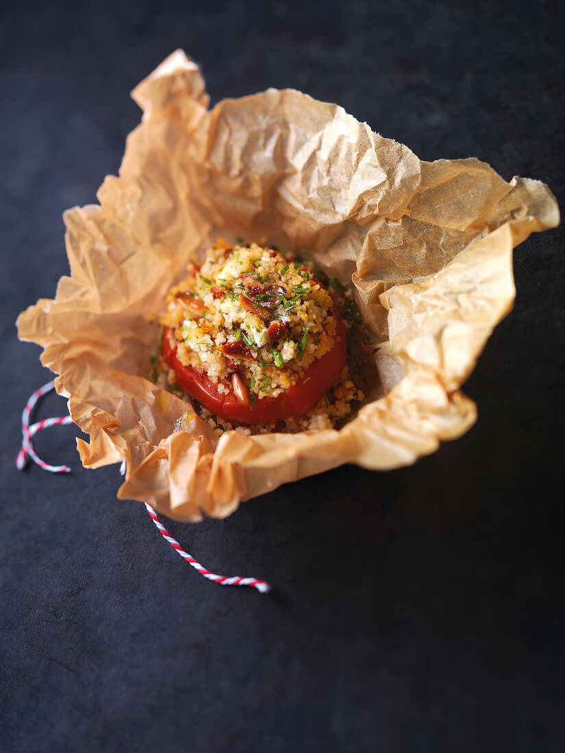 Couscous stuffed tomatoes in baking paper