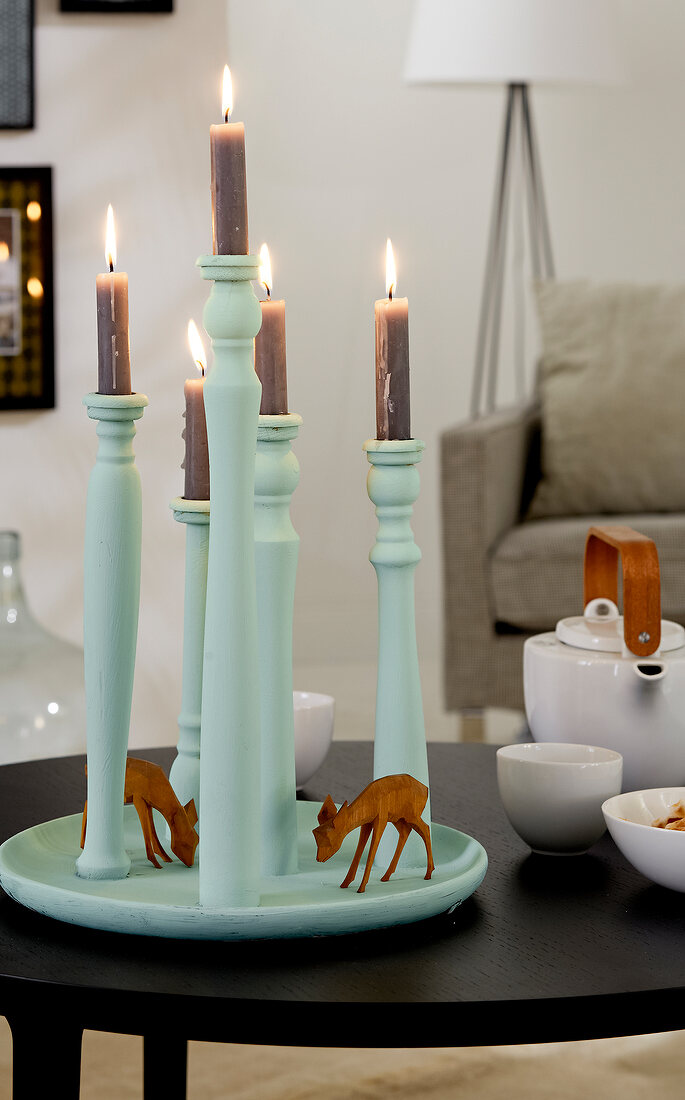 Mint coloured candle plate with lit candles and deer figurines