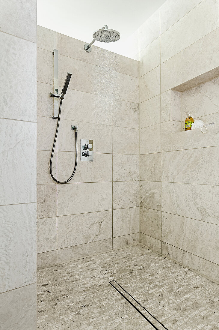 Tiled rain shower with travertine flooring