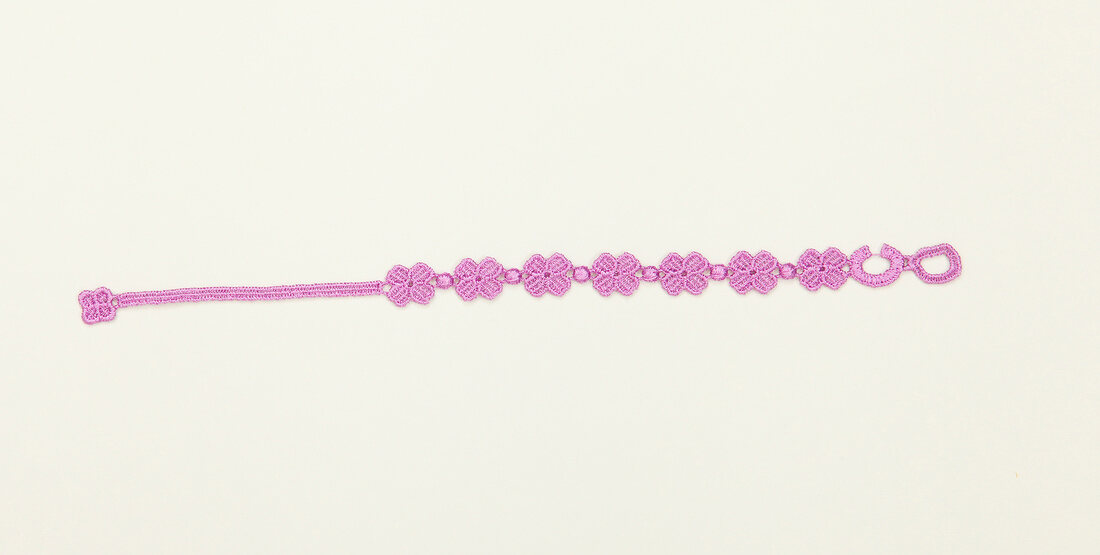 Purple friendship bracelet on white background