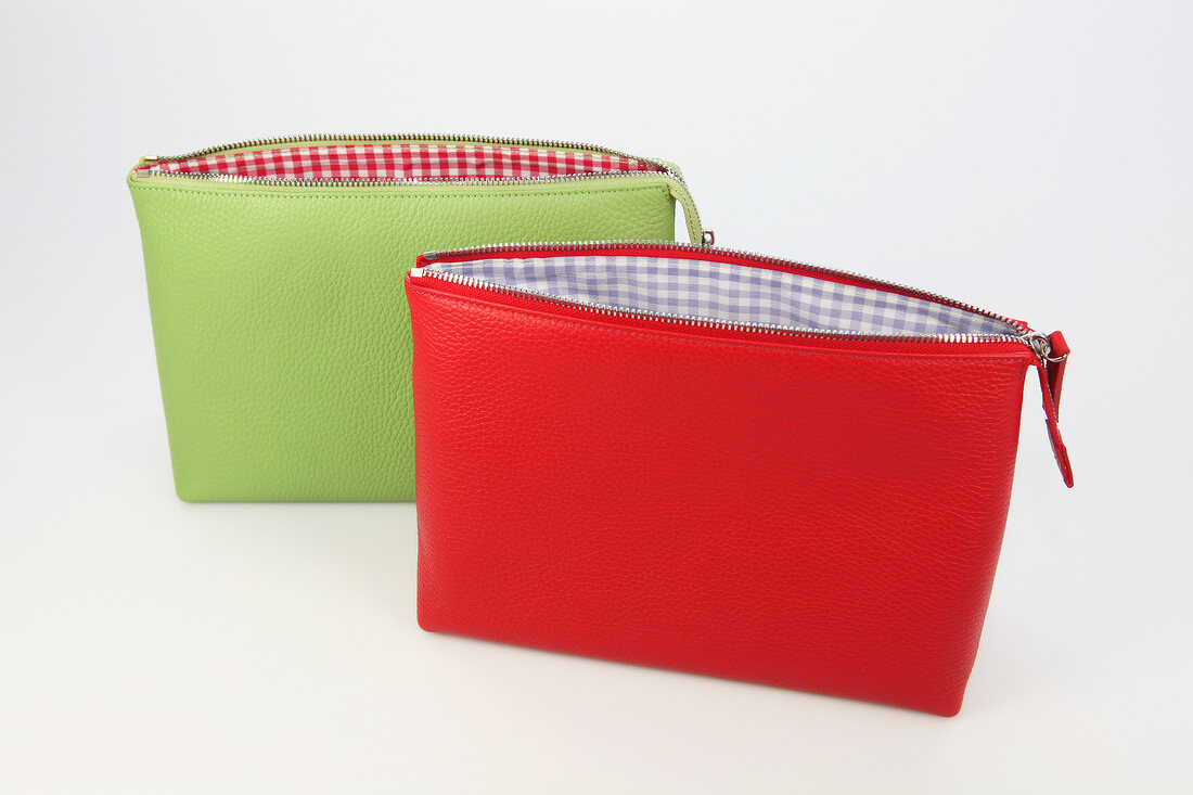 Two green and red pouches on white background
