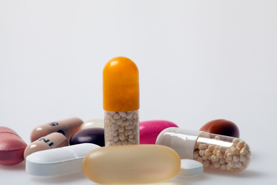 Close-up of different pills, tablets, dragees and capsules on white background