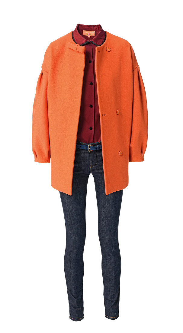 Orange jacket over red shirt and jeans against white background