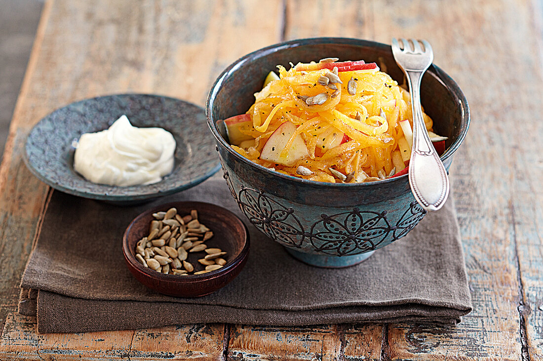 Pumpkin salad with raw apple in bowl