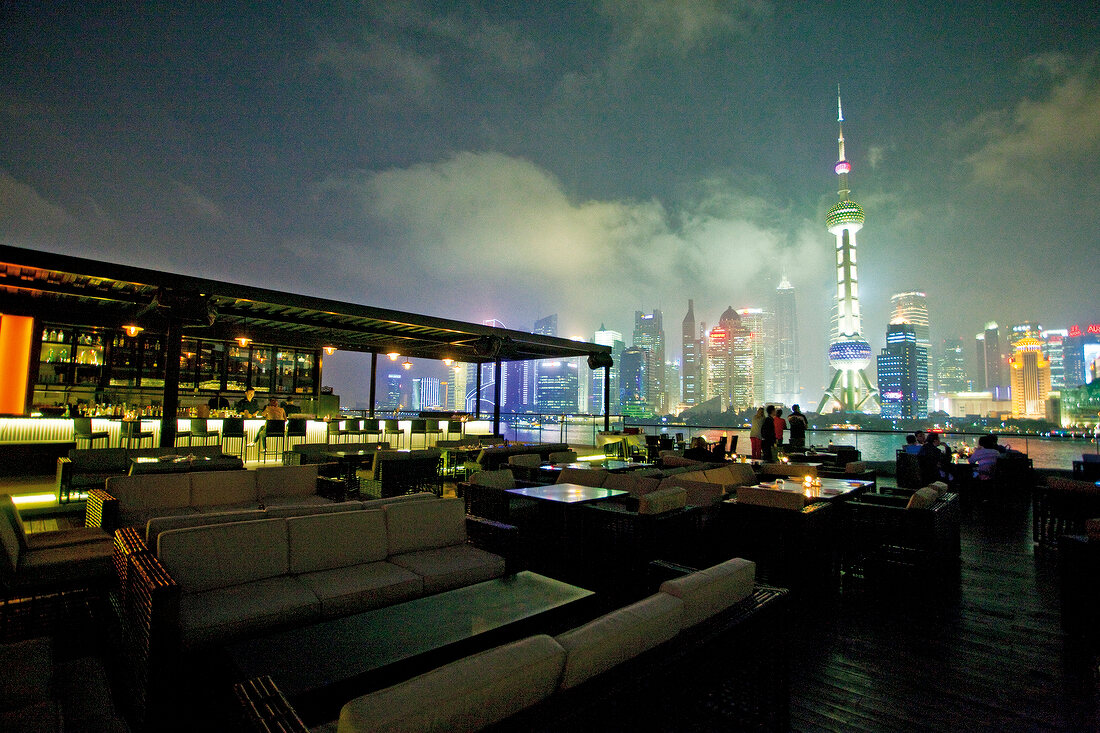 View of skyline and illuminated Restaurant Kathleen's Waitan at night, Shanghai, China