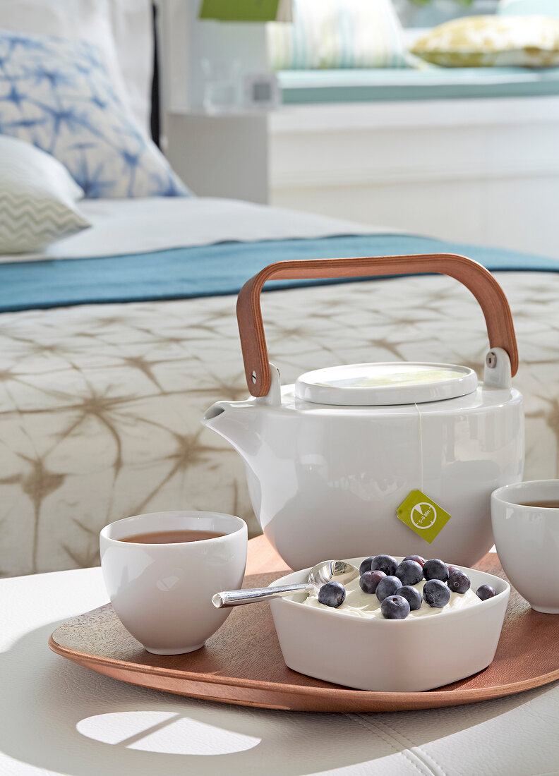 Yoghurt, coffee and tea pot in tray