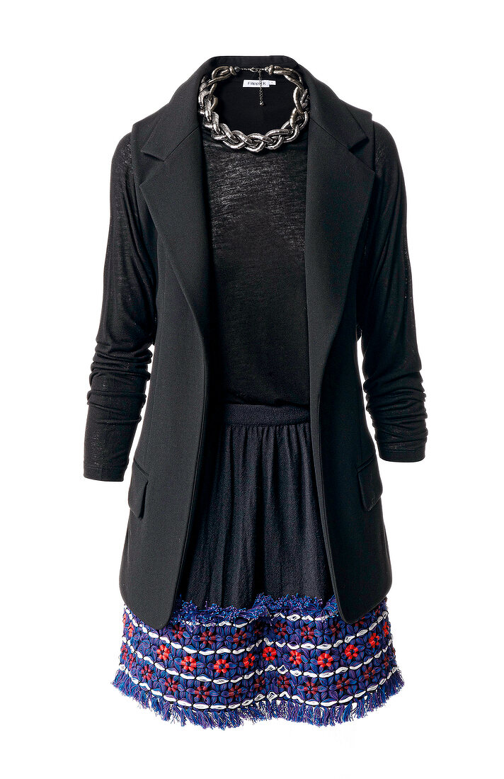 Black coat and embroidered skirt against white background