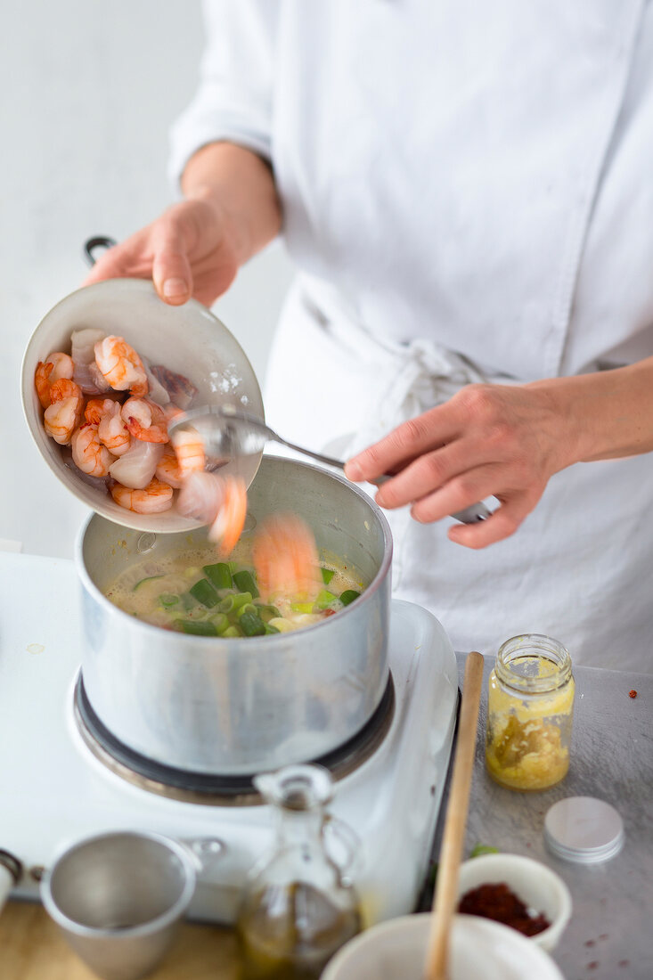 Close-up of chef cutting raw fish on chopping board