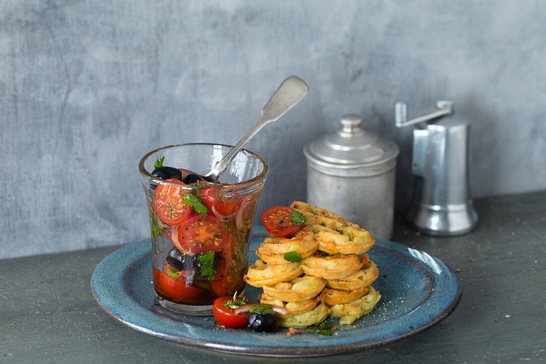 Savoury courgette waffles with a tomato and olive salad