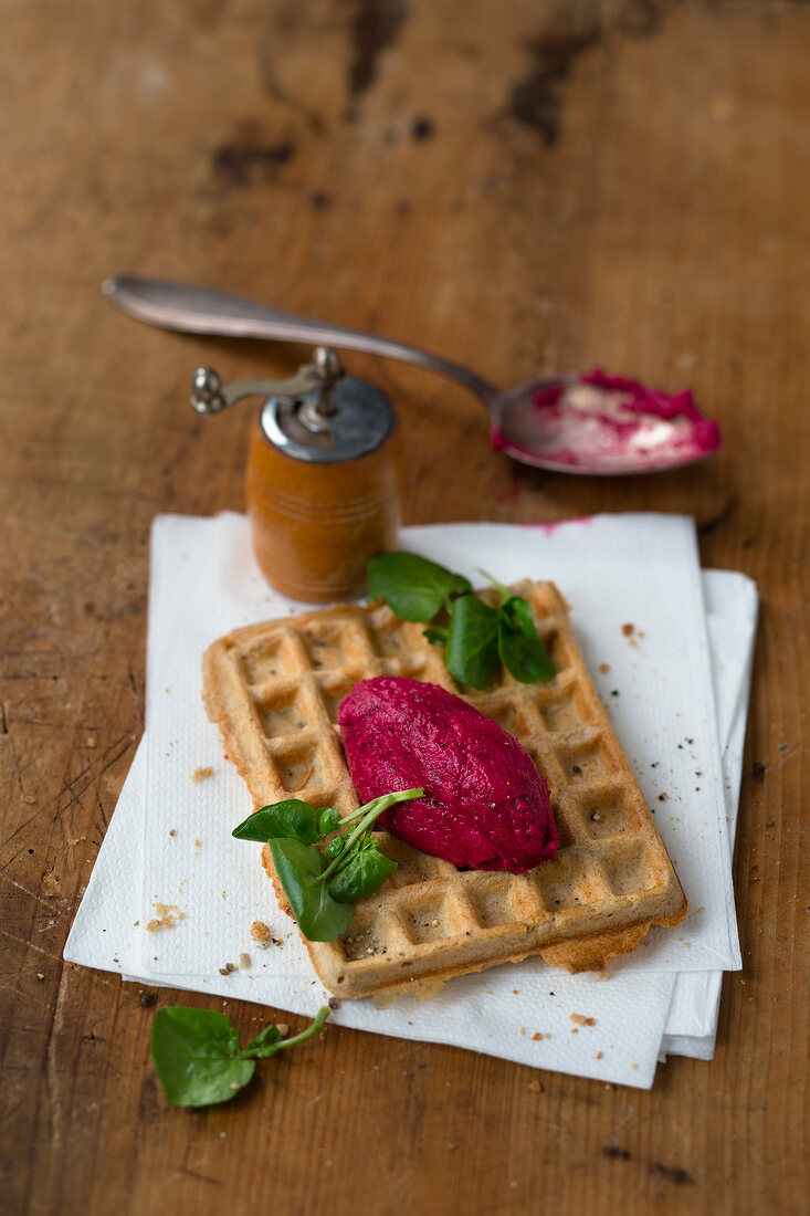 Sourdough waffles with red mousse on tissue papers