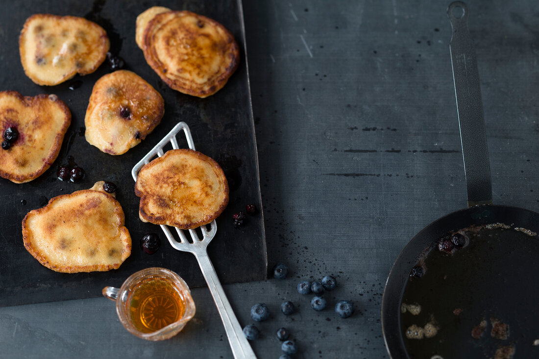 Pancakes on spatula and tray, overhead view