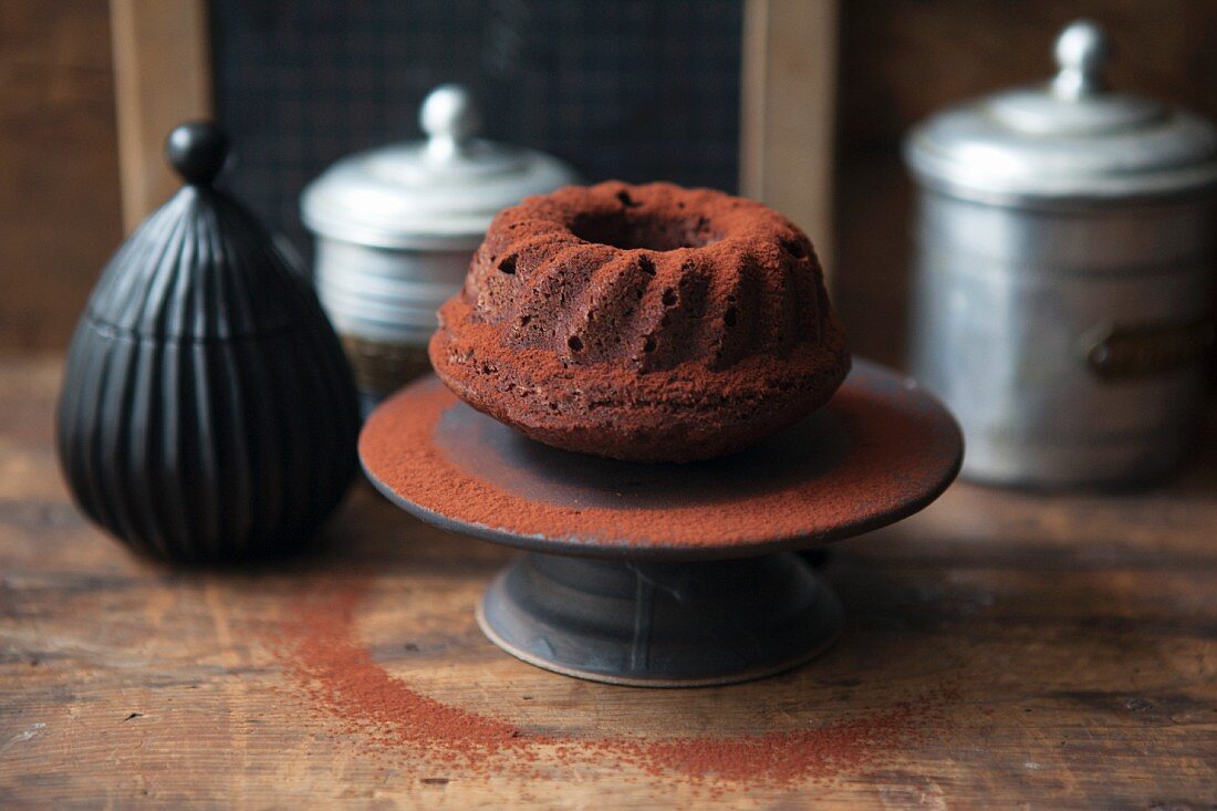 A mini whiskey and chocolate Bundt cake dusted with cocoa powder