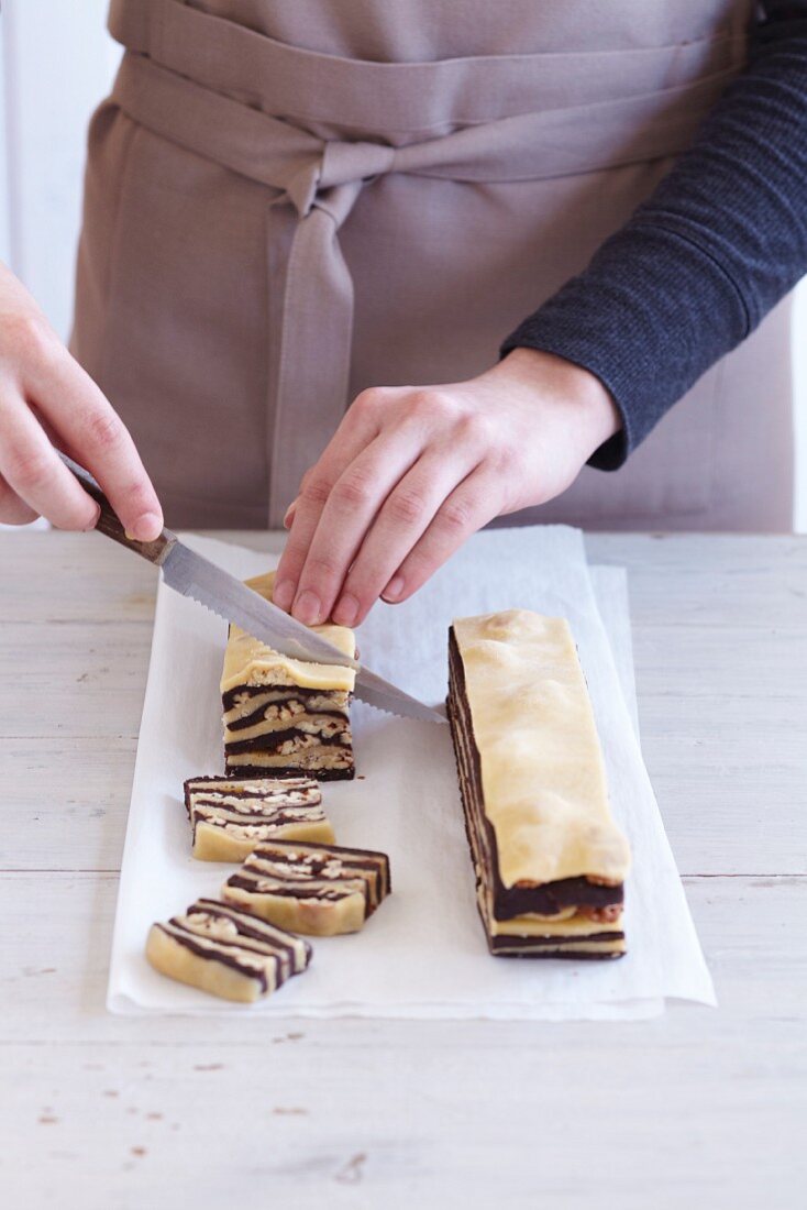 Zebra biscuits being made: layered pastry being sliced