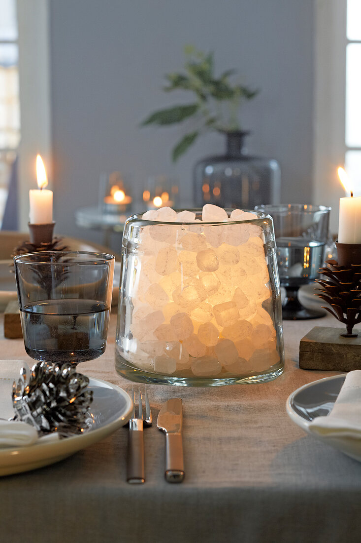 Rock sugar in an illuminated glass as Christmas table decoration