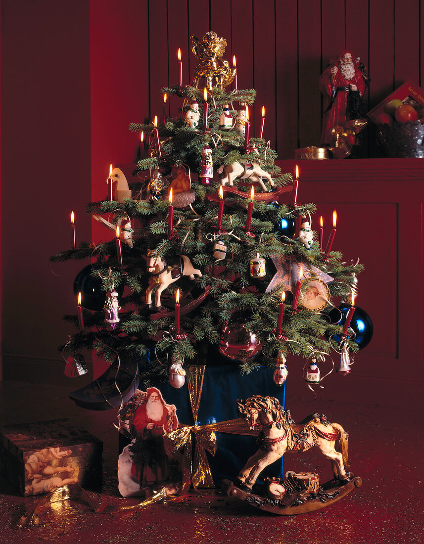Christmas tree with decoration, baubles and lit candles