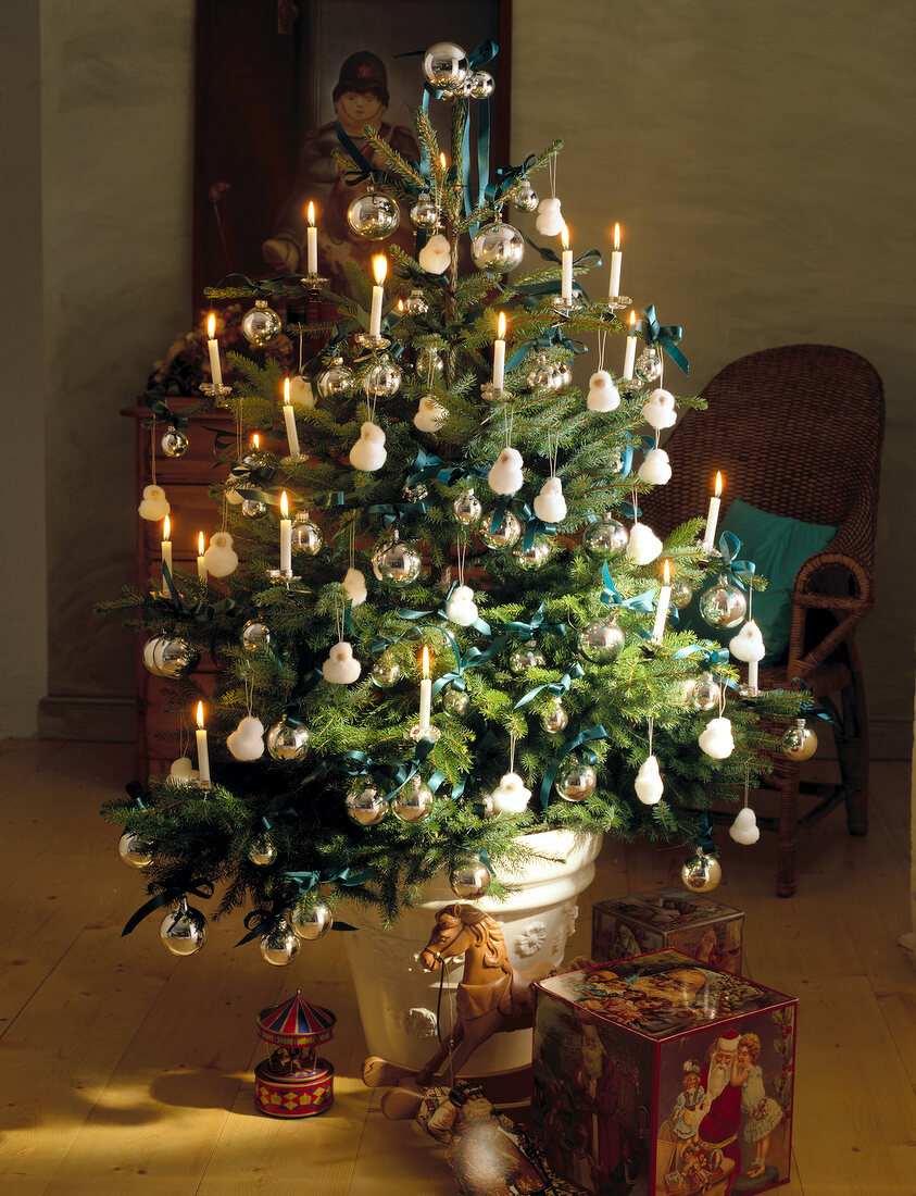 Christmas tree decorated with snowman and lit candles