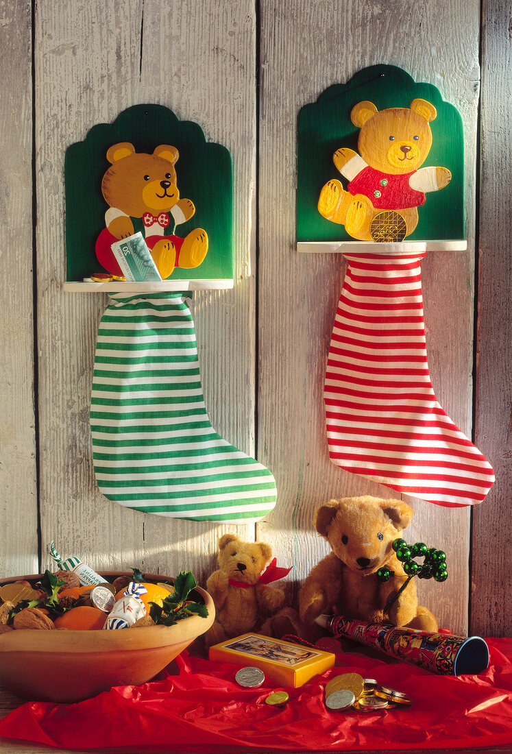 Red and green striped stockings hanging on wall with bear boards