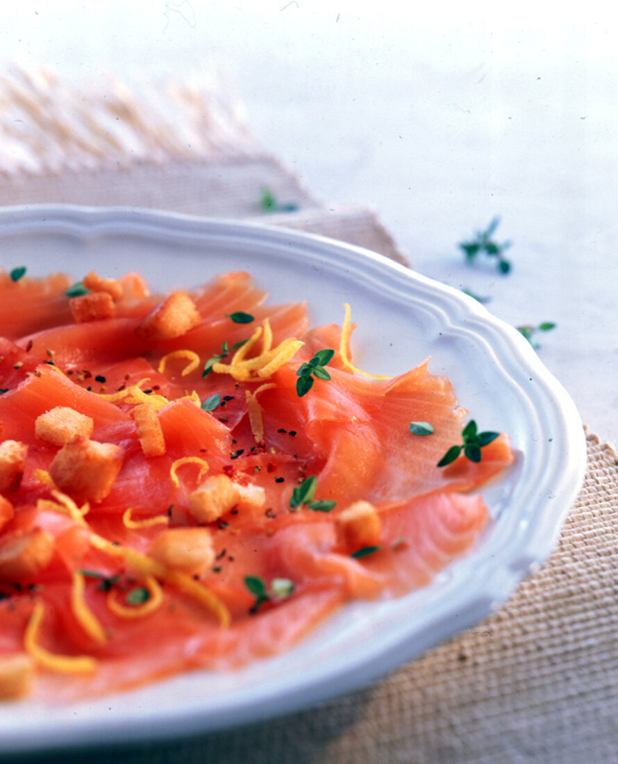 Lachs-Carpaccio mit Thymian-NussCroutons und Zitronenstreifen