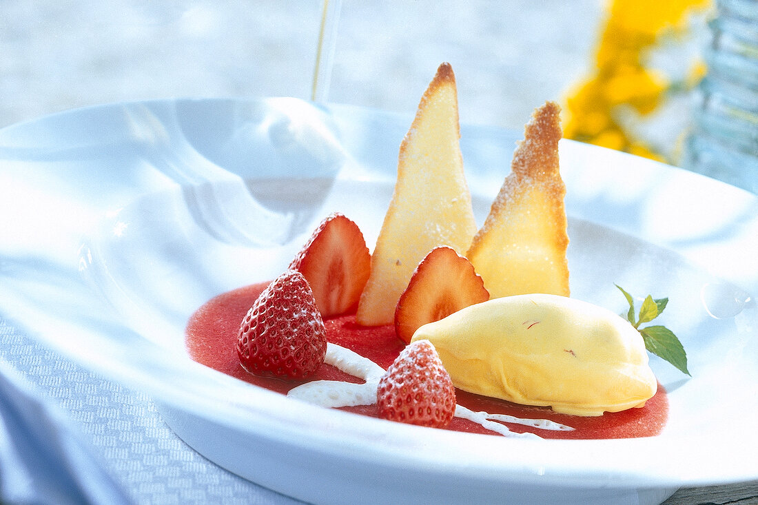 Close-up of dessert with strawberries and saffron in serving dish