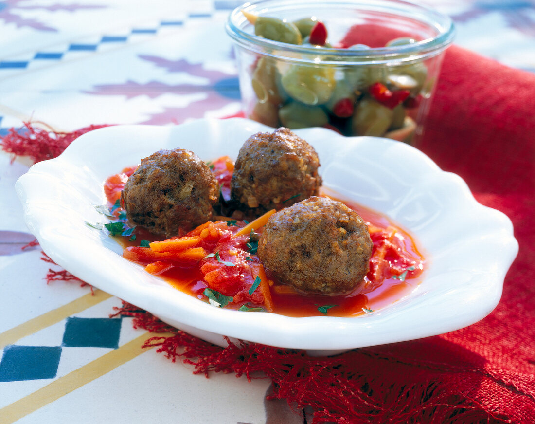 Meatball with tomato and carrot sauce in serving dish