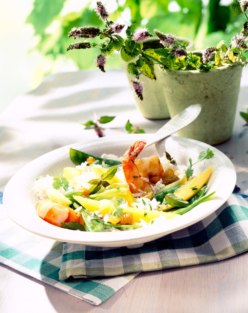 Rice salad with shrimp and mango on plate