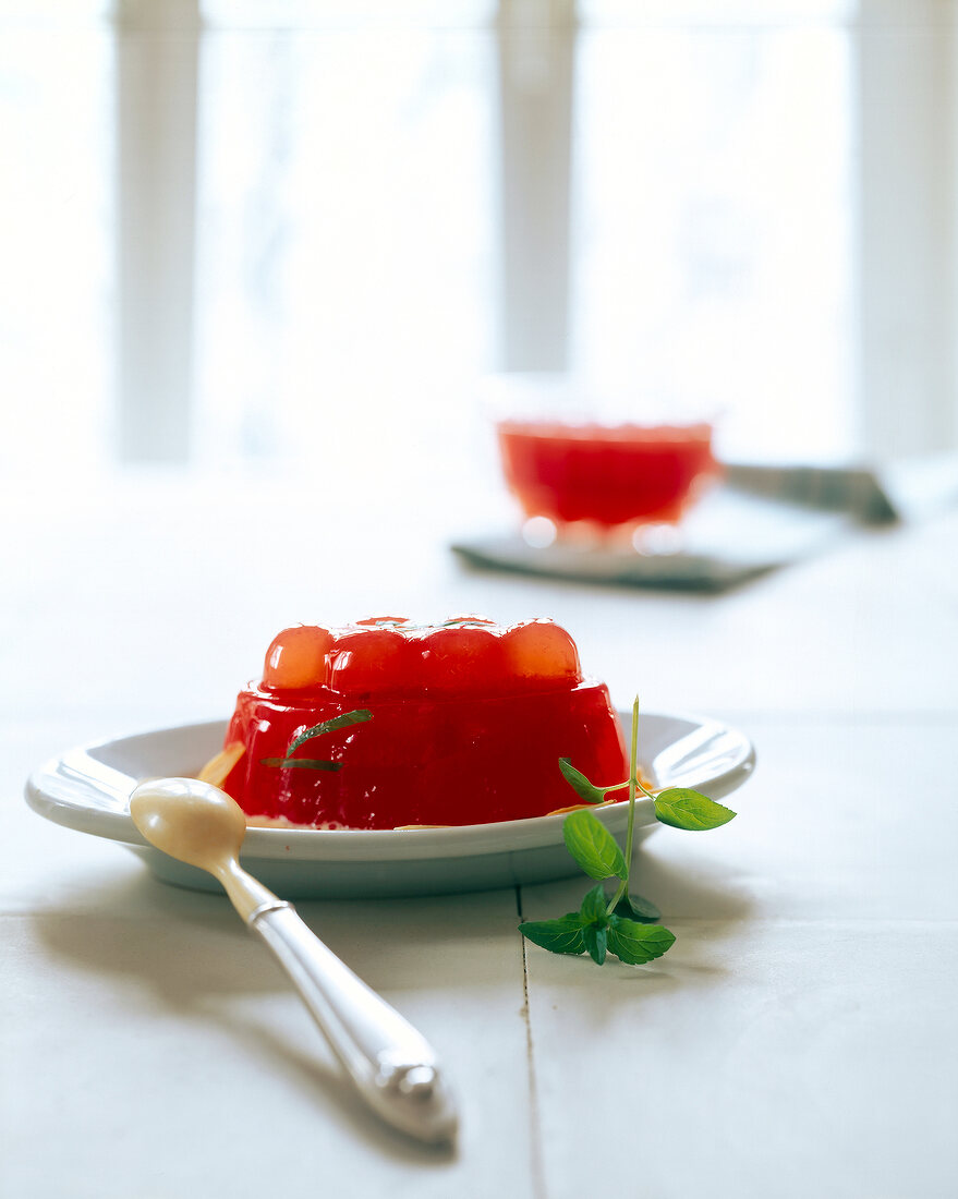 Sabayon dessert and orange jelly on plate