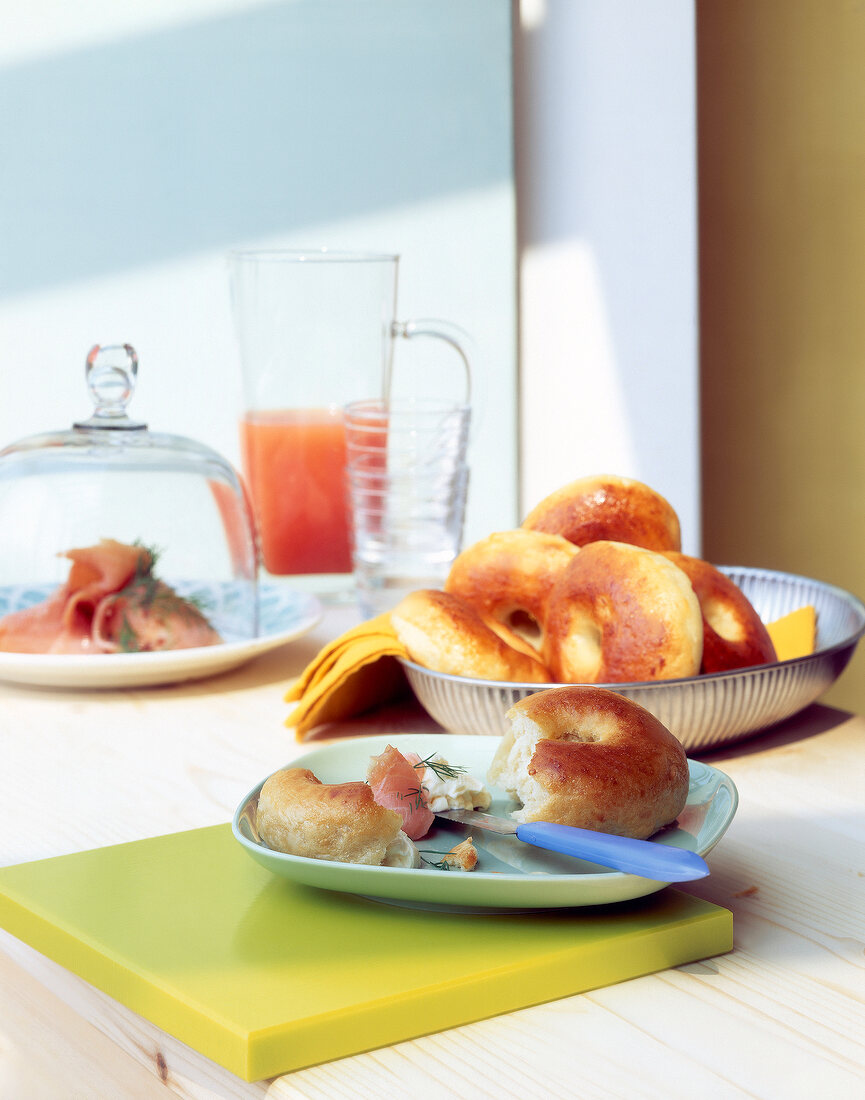 Broken bagel with salmon on plate