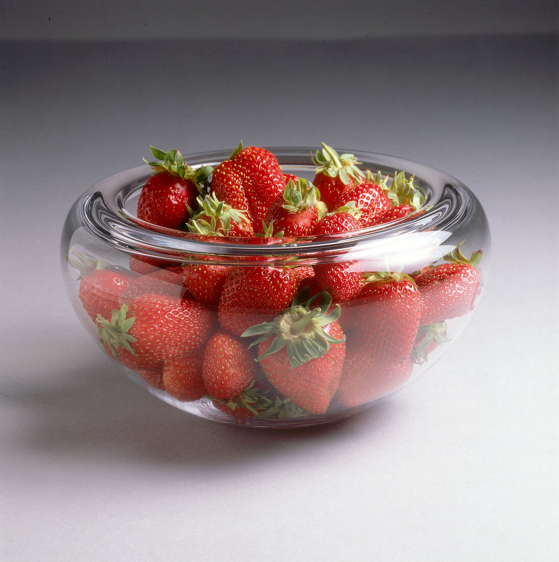 Close-up of glass bowl full of strawberries