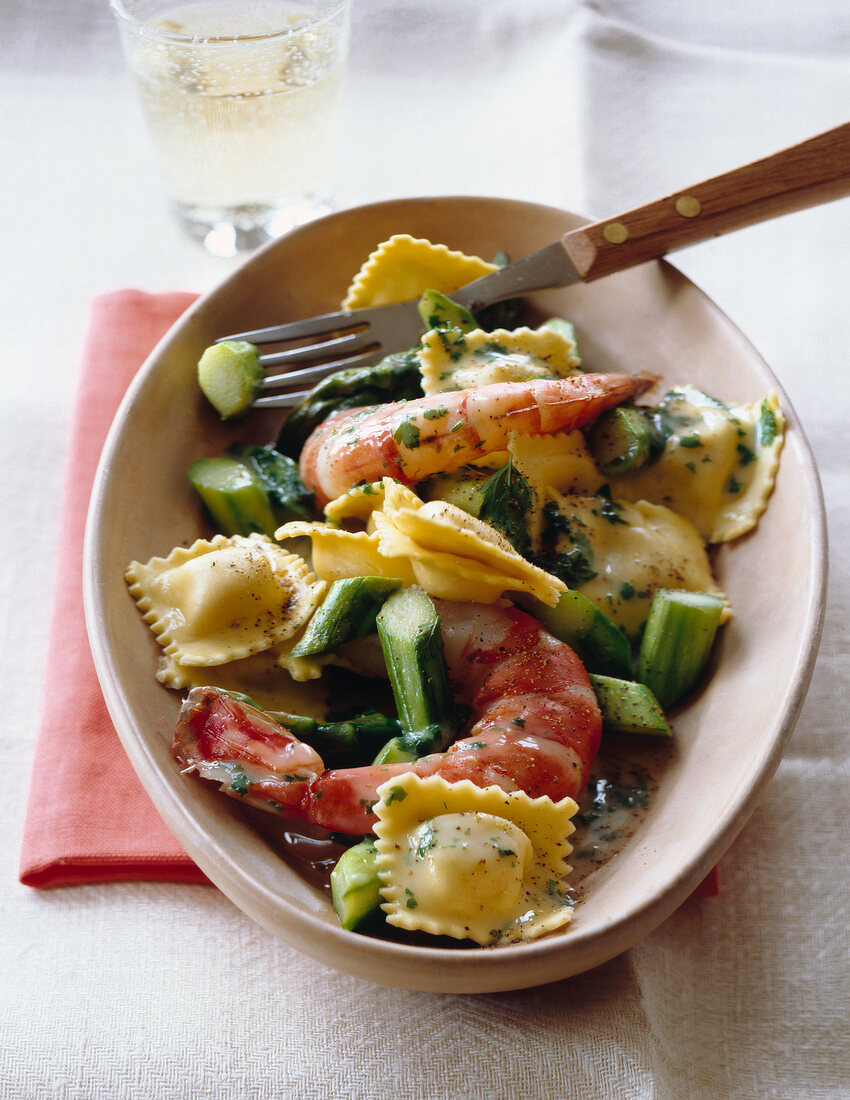 Ravioli with shrimps and green asparagus on plate